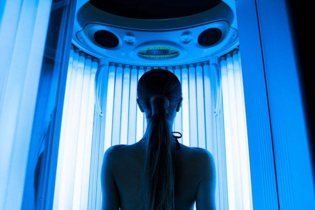 Woman using UV tanning booth at 360 Tan in Bakersfield